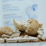 picture of lions mane mushroom capsules and mushroom with packing in background